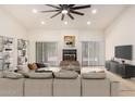 Spacious living room with a fireplace, neutral tones, and ample natural light at 9645 W Kimberly Way, Peoria, AZ 85382