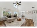 Cozy living room featuring large windows, a comfortable sofa, and an open floor plan at 10252 E Butherus Dr, Scottsdale, AZ 85255
