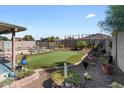 Well maintained backyard features a manicured lawn and small pond at 1057 E Silversmith Trl, San Tan Valley, AZ 85143