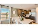 Bright, modern kitchen with stainless appliances and a breakfast bar for casual dining at 11982 E Primrose Ln, Florence, AZ 85132