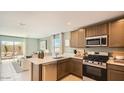 Modern kitchen with stainless steel appliances and a view to the outdoor patio at 11982 E Primrose Ln, Florence, AZ 85132
