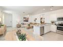 Bright and airy living room, seamlessly connected to the modern kitchen, offers an open concept design for flexible living at 12438 E Verbina Ln, Florence, AZ 85132