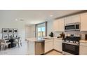 Well-appointed kitchen with stainless steel appliances and access to a dining area and outdoor space at 12469 E Verbina Ln, Florence, AZ 85132