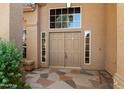 Inviting front entrance featuring a double door with sidelights and decorative stone pathway at 12935 E Mercer Ln, Scottsdale, AZ 85259