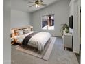 Vaulted ceiling main bedroom with a king bed, fluffy rug, and view to the outside at 13030 W Hearn Rd, El Mirage, AZ 85335