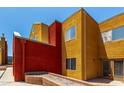 Exterior view of townhome highlighting red and yellow design elements, plus landscaping at 154 W 5Th St # 210, Tempe, AZ 85281
