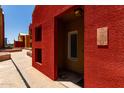 Close-up of unit entrance featuring red facade and modern lighting fixture at 154 W 5Th St # 210, Tempe, AZ 85281