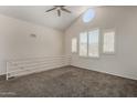Cozy loft space features vaulted ceiling, unique round window, and neutral carpet at 154 W 5Th St # 210, Tempe, AZ 85281