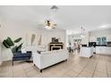 Spacious living room featuring tiled floors, neutral colors, and a cozy fireplace at 1600 N Saba St # 214, Chandler, AZ 85225