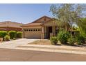 Inviting home with a two-car garage, covered porch, and attractive landscaping at 17038 W Mohave St, Goodyear, AZ 85338