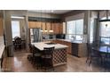Modern kitchen with stainless steel appliances, marble countertops, and a wine rack island at 17658 N 52Nd Pl, Scottsdale, AZ 85254