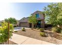 Two-story stucco home featuring a two-car garage, low maintenance landscaping, and covered entryway at 17946 W Via Del Sol --, Surprise, AZ 85387