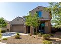 Two-story stucco home featuring a two-car garage, low maintenance landscaping, and covered entryway at 17946 W Via Del Sol --, Surprise, AZ 85387