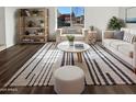 Bright living room featuring modern furniture, stylish decor, and a large window with neighborhood views at 1901 E Hearn Rd, Phoenix, AZ 85022