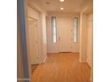 Inviting entryway with wood flooring, white walls, and sidelight windows surrounding the front door at 1970 W Park Pl, Chandler, AZ 85224