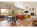 Open living area featuring a fireplace, comfortable furniture, and a bright dining space at 19700 N 76Th St # 1038, Scottsdale, AZ 85255