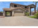 Two-story home featuring desert landscaping, a three-car garage, and a covered patio at 20226 N Madison Dr, Maricopa, AZ 85138