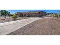 Beautiful single-story home featuring desert landscaping, a tile roof, and a long concrete driveway at 20911 E Excelsior Ave, Queen Creek, AZ 85142