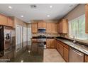 Bright kitchen features wood cabinets, granite countertops, stainless steel appliances, and center island at 21136 N 36Th Pl, Phoenix, AZ 85050