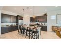 Modern kitchen featuring stainless steel appliances, granite countertops, and a large island at 23098 E Nightingale Rd, Queen Creek, AZ 85142