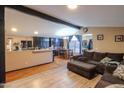 Open-concept living room with wood floors and access to the kitchen and dining area at 245 S 56Th St # 137, Mesa, AZ 85202