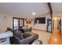 Spacious living room with wood floors, TV, sofa and sliding glass doors to the exterior at 245 S 56Th St # 137, Mesa, AZ 85202