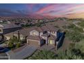 Beautiful two-story home in a well-planned community with mountain views and a colorful sunset at 25155 N 108Th Ave, Peoria, AZ 85383