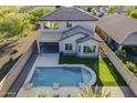 Relax in this backyard oasis featuring a sparkling pool, putting green, covered patio and plenty of room for entertaining at 25155 N 108Th Ave, Peoria, AZ 85383
