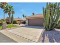 Well-maintained single-story home featuring low maintenance landscaping, desert plants, and a two-car garage at 2984 N 152Nd Dr, Goodyear, AZ 85395