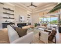 Bright living room featuring a modern fireplace, high ceilings, and a view of the outdoor pool at 3153 E Sierra Vista Dr, Phoenix, AZ 85016