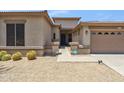 Close-up of a home's exterior with desert landscaping and a covered entryway at 35402 N 32Nd Dr, Phoenix, AZ 85086