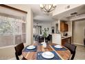 Charming dining area with a round wood table and access to both the kitchen and living room at 3830 E Lakewood E Pkwy # 3014, Phoenix, AZ 85048