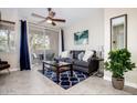Cozy living room featuring a ceiling fan, modern decor, and sliding doors leading to the patio at 3830 E Lakewood E Pkwy # 3014, Phoenix, AZ 85048