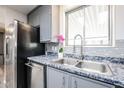 Modern kitchen with granite countertops, stainless steel appliances, and gray cabinets at 4065 E University Dr # 436, Mesa, AZ 85205