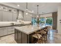 Elegant kitchen with a spacious island, pendant lighting, and stainless steel appliances at 4350 S White Dr, Chandler, AZ 85249