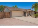 Charming single-story home with a two-car garage, desert landscaping, and a freshly painted exterior at 5350 S River Dr, Tempe, AZ 85283