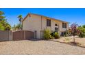 Charming two-story home with desert landscaping, featuring a gated driveway and a light stucco exterior at 7259 E Glencove St, Mesa, AZ 85207