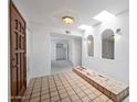 Bright condo foyer with a skylight, unique tile flooring, decorative accents, and a view of the interior at 8314 N 21St Dr # K208, Phoenix, AZ 85021