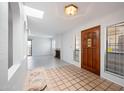 Bright condo foyer with a skylight, unique tile flooring, decorative accents, and a view of the living space at 8314 N 21St Dr # K208, Phoenix, AZ 85021