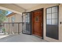 Inviting condo front entrance with a wooden door and secure screen door at 8314 N 21St Dr # K208, Phoenix, AZ 85021