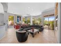 Spacious living room with a fireplace, comfortable seating, and large windows offering great views at 11081 E Betony Dr, Scottsdale, AZ 85255
