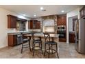 Beautiful kitchen features granite countertops, stainless steel appliances, and an island with breakfast bar seating at 11866 N 143Rd Ave, Surprise, AZ 85379