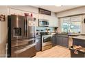 Galley kitchen featuring stainless steel appliances and ample cabinet space at 13802 N 37Th Dr, Phoenix, AZ 85053