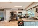Well-lit kitchen with modern appliances, breakfast bar, and a view to the exterior at 13802 N 37Th Dr, Phoenix, AZ 85053