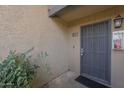 Ground floor entrance with security door and exterior lighting at 1402 E Guadalupe Rd # 122, Tempe, AZ 85283