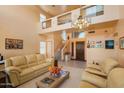 Inviting living room with a staircase, neutral tones, and a view of the home's entrance at 14186 N 100Th Pl, Scottsdale, AZ 85260
