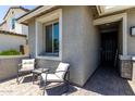 Inviting front porch area with comfortable seating and a stylish entryway at 20926 E Longwood Dr, Queen Creek, AZ 85142