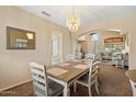 Cozy dining room featuring chandelier and a view to the living room at 25818 N 68Th Ave, Peoria, AZ 85383