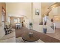 Bright living room with stairs, dining area, and neutral decor creating a welcoming space at 25818 N 68Th Ave, Peoria, AZ 85383