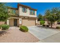 Inviting two-story home showcasing desert landscaping, covered porch, and a two-car garage at 263 N Wilson Dr, Chandler, AZ 85225